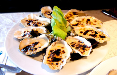 Fresh seafood platter with cooked oysters on the table