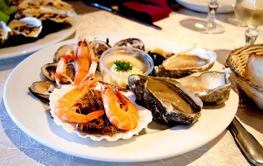 Fresh seafood platter with lobster, shrimps  and oysters on the table