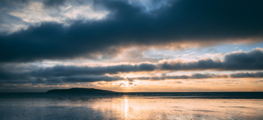 Bright sunrise on beach in Rush Ireland