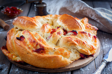 Cooked round cake made from yeast dough with dried tomatoes and cheese, horizontal