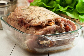 Marinated raw pork roll ready to roast