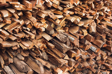 Stacks of dry textured firewood closeup. Toned photo.