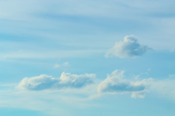 Blue sky background with tiny clouds. White fluffy clouds in the blue sky - 191330022