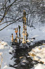 High towers of balanced stones on a background of a winter forest.