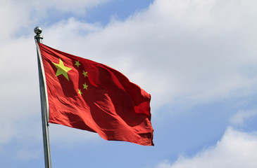 Chinese flag waving in the wind on a sunny day