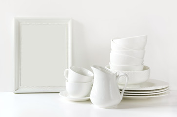 White tableware for serving. Crockery,dish, utensils and other different white stuff on white...