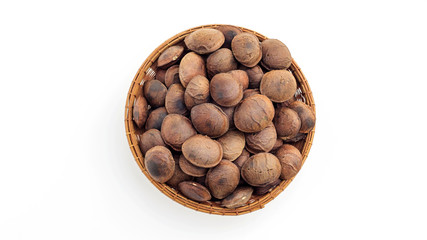 Sacha Inchi seeds in a basket on a white background.