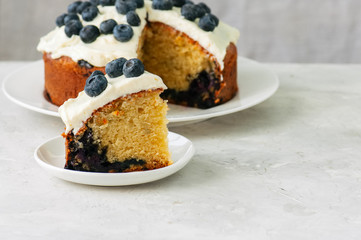 Basil walnut pesto in a jar with raw ingredients on a wooden board. White stone background. Copy space.