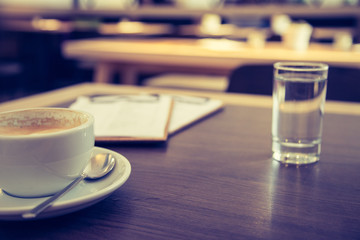 Kaffeetasse mit Wasserglas auf Holztisch. Konzept.