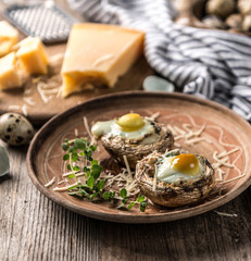 Stuffed mushrooms with quail eggs and parmesan cheese.