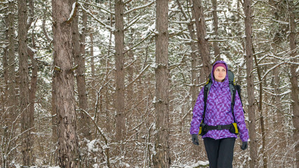 Woman Hiking with Big Backpack in Beautiful Winter Forest