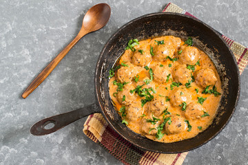 Tasty homemade meatballs in creamy tomato sauce