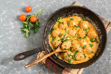 Tasty homemade meatballs in creamy tomato sauce