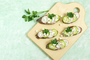 Spring vitamin toasts with cottage cheese, radish and cucumber