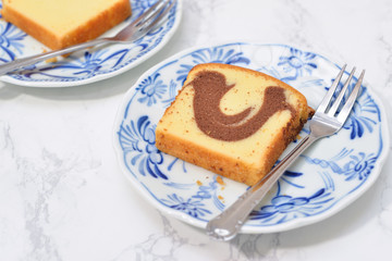 Slice of Marble cake on blue plate