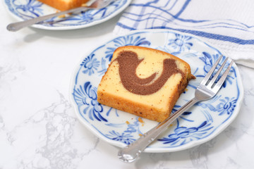Slice of Marble cake on blue plate