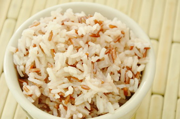 Mixed red cargo rice in cup on bamboo plate