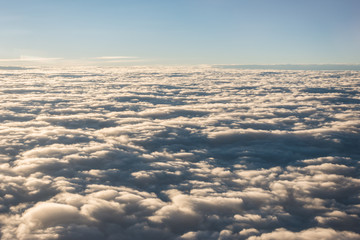 Beautiful view of cloud and sky from the windows of airplane flying when the sunrise