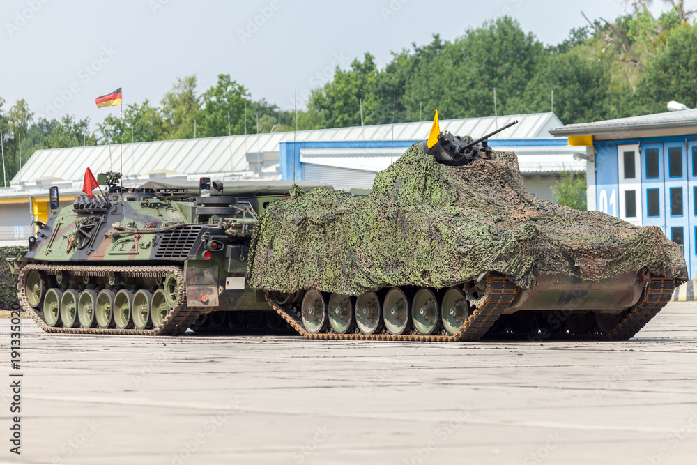 Wall mural german armored recovery tank pulls a damaged tank