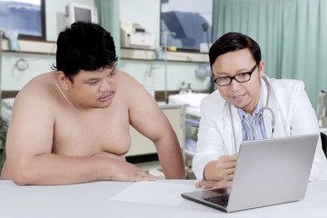 Overweight patient consulting with a doctor