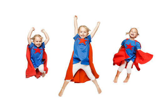 Very Excited Little Girl Dressed Like Hero Jumping Isolated On White Background.