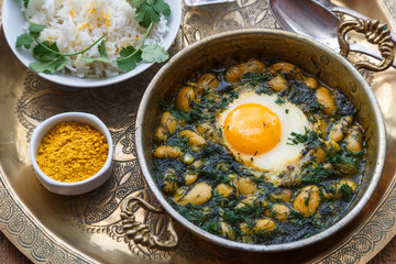 Persian breakfast with eggs, bean and dill in copper pan - obrazy, fototapety, plakaty