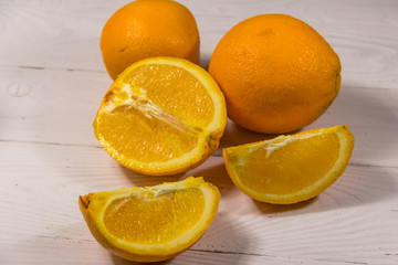 Fresh oranges on white wooden table