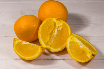 Fresh oranges on white wooden table