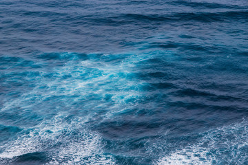 Naklejka na ściany i meble Water pattern after wave breaking in the ocean.
