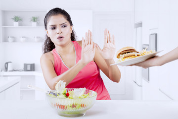 Indian woman refusing hamburger