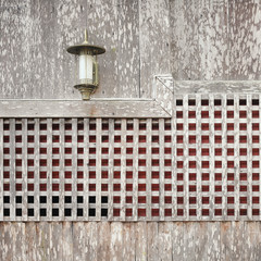 Lamp on wooden wall background
