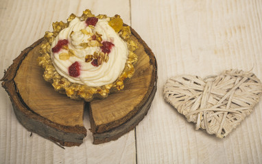Cupcake and heart decor on wooden background