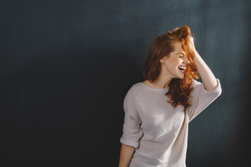 Fun young woman enjoying a good hearty laugh