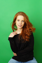 Obraz premium Pretty young woman with long red hair