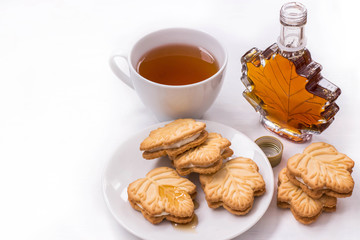 black tea Cup, maple syrup and maple syrup cookies on white background