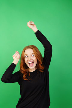 Young enthusiastic woman against green background