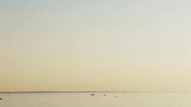 sunset timelapse over fin gulf baltic sea with small clouds and volumetric light