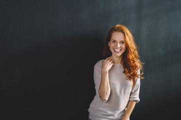 Happy vivacious young redhead woman