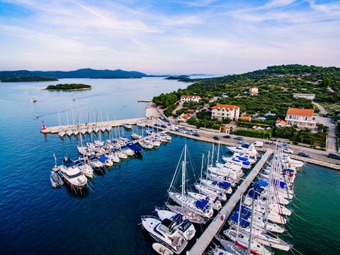 Fototapeta Aerial drone view of small marina with boats and yachts docked in Croatia