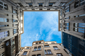 Tenement house atrium and sky view from long angle perspective