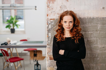 Intense young woman with folded arms