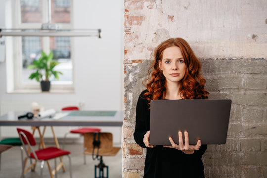 Woman standing with laptop