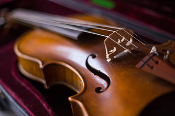 Violin and bow in dark red case.