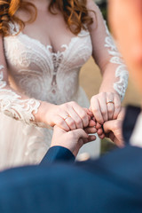 Loving couple holding hands with rings
