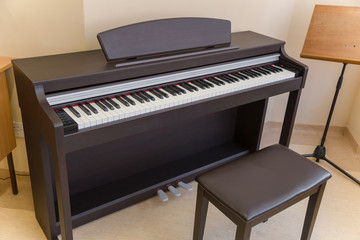 modern wooden black piano in music classrom