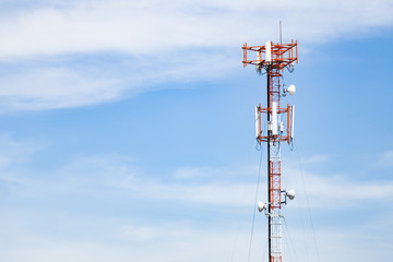 Mobile phone communication antenna tower with the blue sky and clouds
