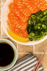 Hawaiian Poke Bowl Of Salmon Sashimi With Rice Noodles And Spring Onions