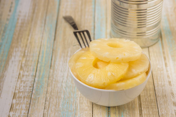 Canned pineapple rings. Ananas slices in a white bowl
