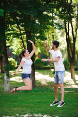 A young couple celebrate victory playing tic-tac-toe in the park