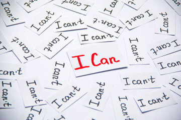 I can. Words of motivation. Concept motivational message of ability and possibility. I can`t and i can are written on peaces of white paper.